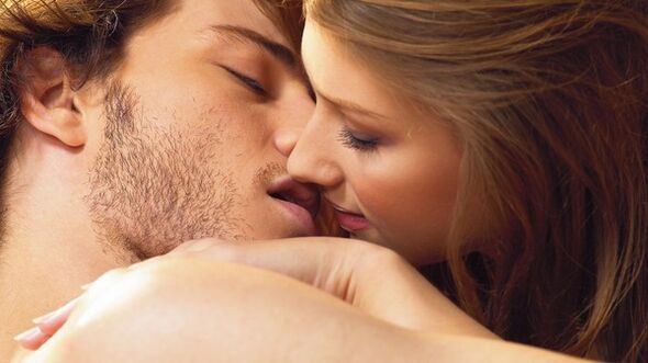 a woman kisses a man with products to increase potency